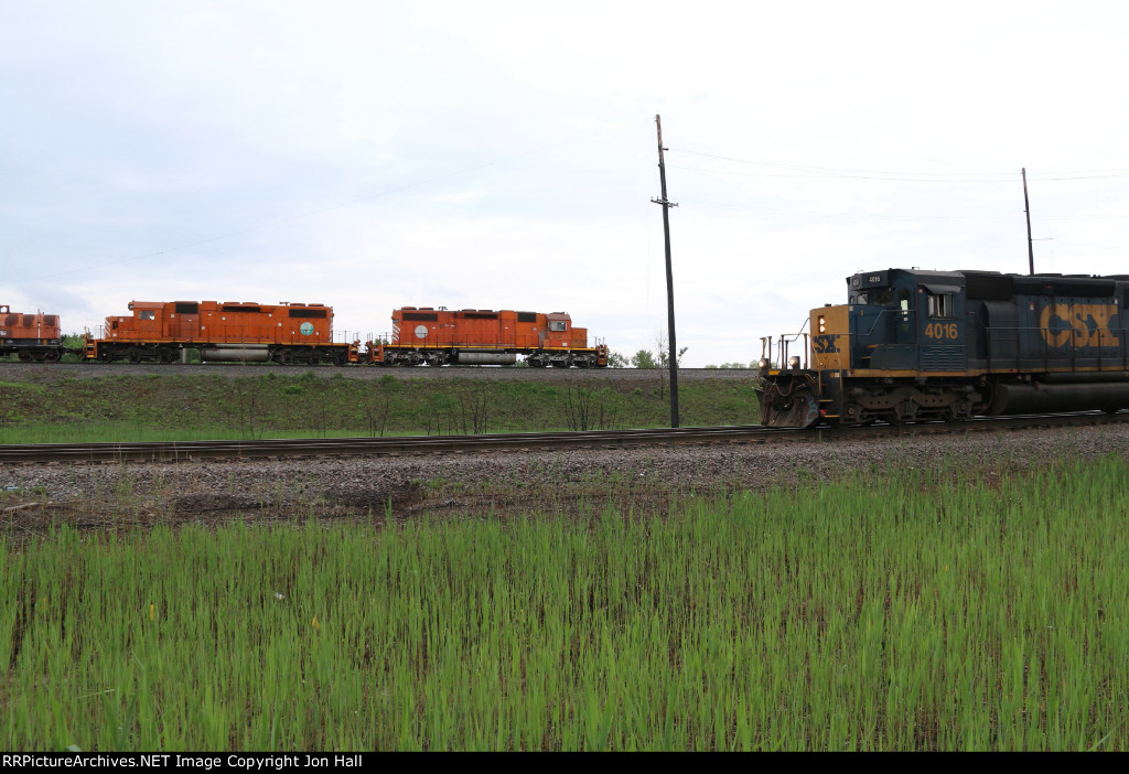 A pair ob EJ&E SD38-2's work their old home rails as a CSX job passes in front